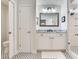 Bright bathroom with mosaic floors, white vanity, a framed mirror, and a shower at 3503 Graycliff Ln, Brandon, FL 33511