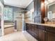 Luxurious bathroom with double vanity, granite countertop, and glass enclosed shower at 3503 Graycliff Ln, Brandon, FL 33511