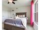 Cozy bedroom featuring a decorative ceiling fan, and a large window with pink curtains at 3503 Graycliff Ln, Brandon, FL 33511