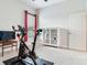 Bright bedroom featuring an exercise bike, television, carpet, and natural light at 3503 Graycliff Ln, Brandon, FL 33511