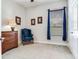 Bedroom showcasing a blue armchair, dresser, carpet, and window with blinds at 3503 Graycliff Ln, Brandon, FL 33511