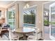 Bright breakfast nook with pool views, table seating, and modern lighting at 3503 Graycliff Ln, Brandon, FL 33511