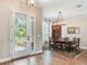 This formal dining room features a glass front door and a decorative chandelier at 3503 Graycliff Ln, Brandon, FL 33511