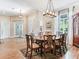 Bright dining area featuring crown molding, a chandelier, and views to the back yard at 3503 Graycliff Ln, Brandon, FL 33511