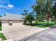 The home boasts a three-car garage and a well-manicured lawn at 3503 Graycliff Ln, Brandon, FL 33511