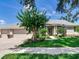Charming single-story home features a manicured lawn and a three-car garage at 3503 Graycliff Ln, Brandon, FL 33511
