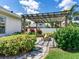 Cozy backyard fire pit area with stone pavers, seating and lush landscaping at 3503 Graycliff Ln, Brandon, FL 33511