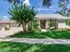 Beautiful single-story home featuring a three-car garage, manicured lawn, and inviting front entrance at 3503 Graycliff Ln, Brandon, FL 33511