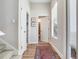 Hallway featuring wood flooring, stair access, and an open view to the guest bathroom at 3503 Graycliff Ln, Brandon, FL 33511