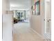 Inviting hallway leading to a living room with a large window and comfortable seating at 3503 Graycliff Ln, Brandon, FL 33511