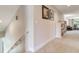 Hallway with carpet, artwork, and a partial view of a living room featuring natural light at 3503 Graycliff Ln, Brandon, FL 33511