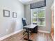 Well-lit office space with desk, large window, and view of the yard at 3503 Graycliff Ln, Brandon, FL 33511