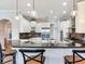 Stylish kitchen with white cabinets, a stainless steel refrigerator, and bar seating at 3503 Graycliff Ln, Brandon, FL 33511