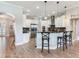 Modern kitchen featuring white cabinets, stainless steel appliances, and a stylish bar area at 3503 Graycliff Ln, Brandon, FL 33511