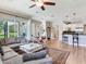 Open-concept living area with hardwood floors, kitchen bar, and sliding glass doors to the outdoors at 3503 Graycliff Ln, Brandon, FL 33511