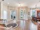 Spacious living area with wood floors, glass doors, and open layout to a dining area at 3503 Graycliff Ln, Brandon, FL 33511