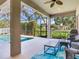 Screened patio with a swimming pool, ceiling fan, and comfortable outdoor seating area at 3503 Graycliff Ln, Brandon, FL 33511