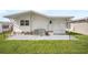 Backyard patio with lush grass, providing a private outdoor retreat and air conditioning at 35045 Cynthia Ave # 35945, Zephyrhills, FL 33541