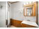 The bathroom features a wood vanity, tiled walls, and a glass enclosed shower for a spa-like experience at 35045 Cynthia Ave # 35945, Zephyrhills, FL 33541