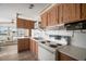 Cozy kitchen features wood cabinets, white countertops, and modern appliances in an inviting atmosphere at 35045 Cynthia Ave # 35945, Zephyrhills, FL 33541