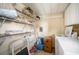 Convenient laundry room with shelving, storage and laundry machines for effortless chores at 35045 Cynthia Ave # 35945, Zephyrhills, FL 33541