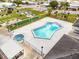Aerial shot featuring an uniquely shaped pool and hot tub with the putting range visible in the background at 35045 Cynthia Ave # 35945, Zephyrhills, FL 33541