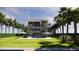 Expansive backyard featuring a modern home, manicured lawn, tall palm trees, and a sparkling swimming pool at 3611 Bayshore Ne Blvd, St Petersburg, FL 33703