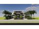 Stunning modern home featuring lush tropical landscaping, a multi-story design, and a sleek, minimalist aesthetic at 3611 Bayshore Ne Blvd, St Petersburg, FL 33703
