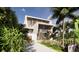 Striking angle view of a modern home featuring tropical landscaping and a winding drive way at 3611 Bayshore Ne Blvd, St Petersburg, FL 33703