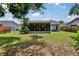 Backyard view of the house, patio, and the fenced in yard at 3733 Mendocino St, New Port Richey, FL 34655