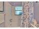 Updated bathroom with white subway tile and a blue and white decorative shower curtain at 3733 Mendocino St, New Port Richey, FL 34655