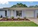 Charming home with a well-kept lawn and colorful potted plants along the front porch at 3733 Mendocino St, New Port Richey, FL 34655