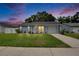 Charming single-story home with a well-manicured lawn during twilight hours at 3733 Mendocino St, New Port Richey, FL 34655