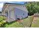 View of the attached garage, yard and fenced-in backyard at 3733 Mendocino St, New Port Richey, FL 34655