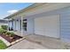 Close up view of the attached garage and small garden in the front yard at 3733 Mendocino St, New Port Richey, FL 34655