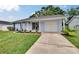 Charming single-story home with a well-manicured lawn, garage, and flower garden at 3733 Mendocino St, New Port Richey, FL 34655