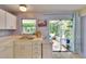 Charming kitchen with stainless steel sink, granite countertops, and access to the screened patio at 3733 Mendocino St, New Port Richey, FL 34655