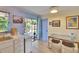 Bright kitchen featuring stainless steel sink, wood floors, and access to the screened in patio at 3733 Mendocino St, New Port Richey, FL 34655