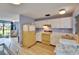 Kitchen features wood floors, white cabinets and classic appliances at 3733 Mendocino St, New Port Richey, FL 34655