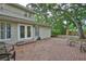 Brick patio and mature trees frame the home's backyard and outdoor entertaining space at 3906 W San Luis St, Tampa, FL 33629