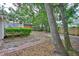 Leafy backyard featuring a deck, small storage shed, and brick pathway at 3906 W San Luis St, Tampa, FL 33629