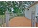 This home features a spacious wooden deck with railing to enjoy the nature view in the back yard at 3906 W San Luis St, Tampa, FL 33629