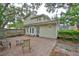Spacious backyard featuring brick patio and lush, mature trees providing ample shade at 3906 W San Luis St, Tampa, FL 33629