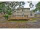 This home has a wooden deck with a railing and a cozy outdoor space to relax and entertain at 3906 W San Luis St, Tampa, FL 33629