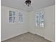 Sunlit bedroom features neutral carpet, plantation shutters, and a modern ceiling light at 3906 W San Luis St, Tampa, FL 33629