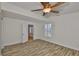 Bright bedroom featuring wood flooring, neutral walls, and a ceiling fan at 3906 W San Luis St, Tampa, FL 33629