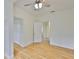 Cozy bedroom featuring hardwood floors, ceiling fan, and convenient closet access at 3906 W San Luis St, Tampa, FL 33629