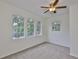 This light-filled bedroom features neutral carpet and three windows for natural light at 3906 W San Luis St, Tampa, FL 33629