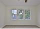This light-filled bedroom features neutral carpet and three windows for natural light at 3906 W San Luis St, Tampa, FL 33629