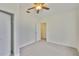 A bright bedroom features neutral carpet, a fan, and a closet for ample storage at 3906 W San Luis St, Tampa, FL 33629